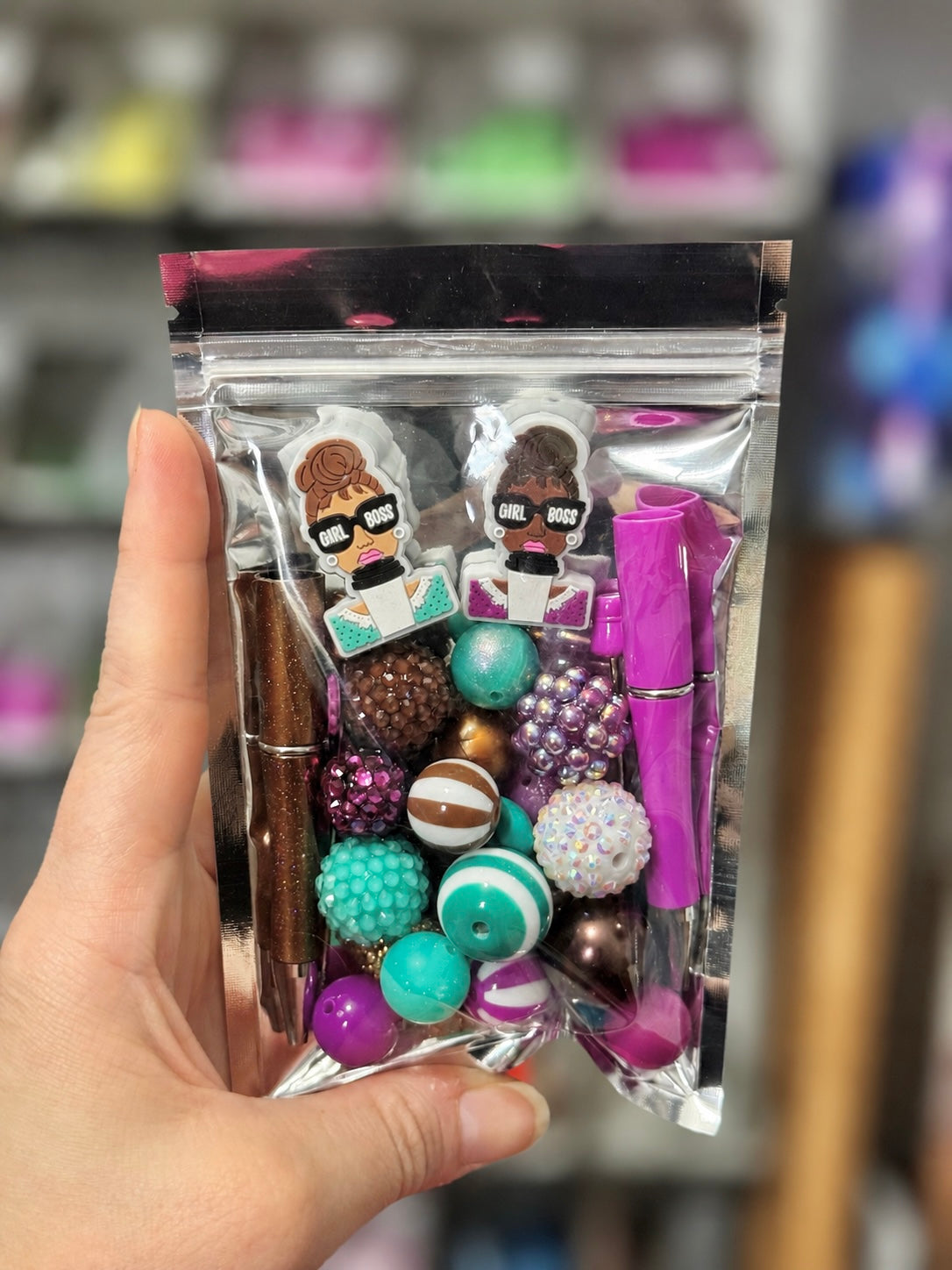 Girl Boss 30-piece curated pen kit with purple, turquoise and brown beads, two silicone focals and two beadable pens