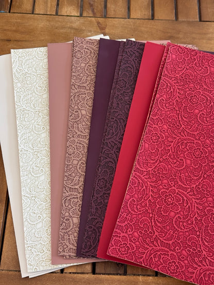 Faux leather lace sheets paired with matching solids in ivory, dusty rose, plum and red