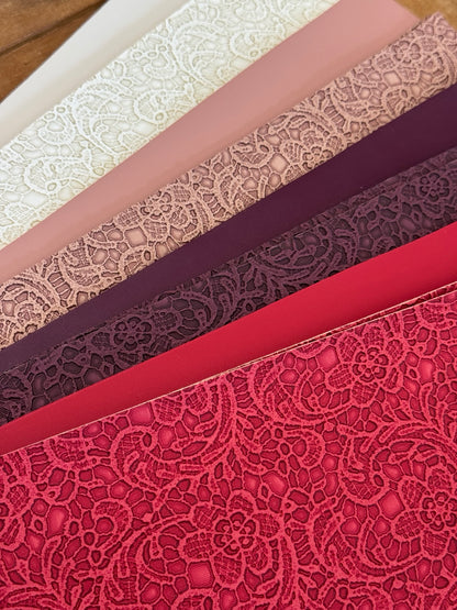 Faux leather lace sheets paired with matching solids in ivory, dusty rose, plum and red