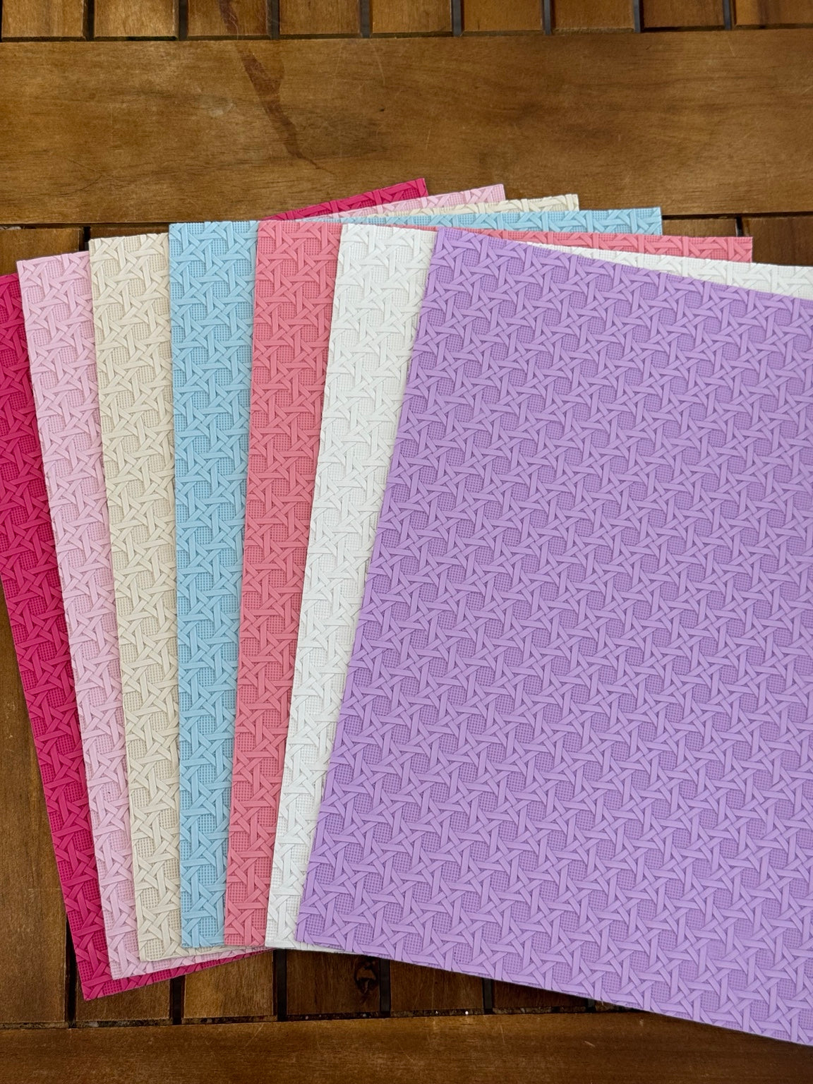 Cross hatch textured faux leather sheets in fuchsia, pale pink, cream, light blue, coral pink, white and lavender