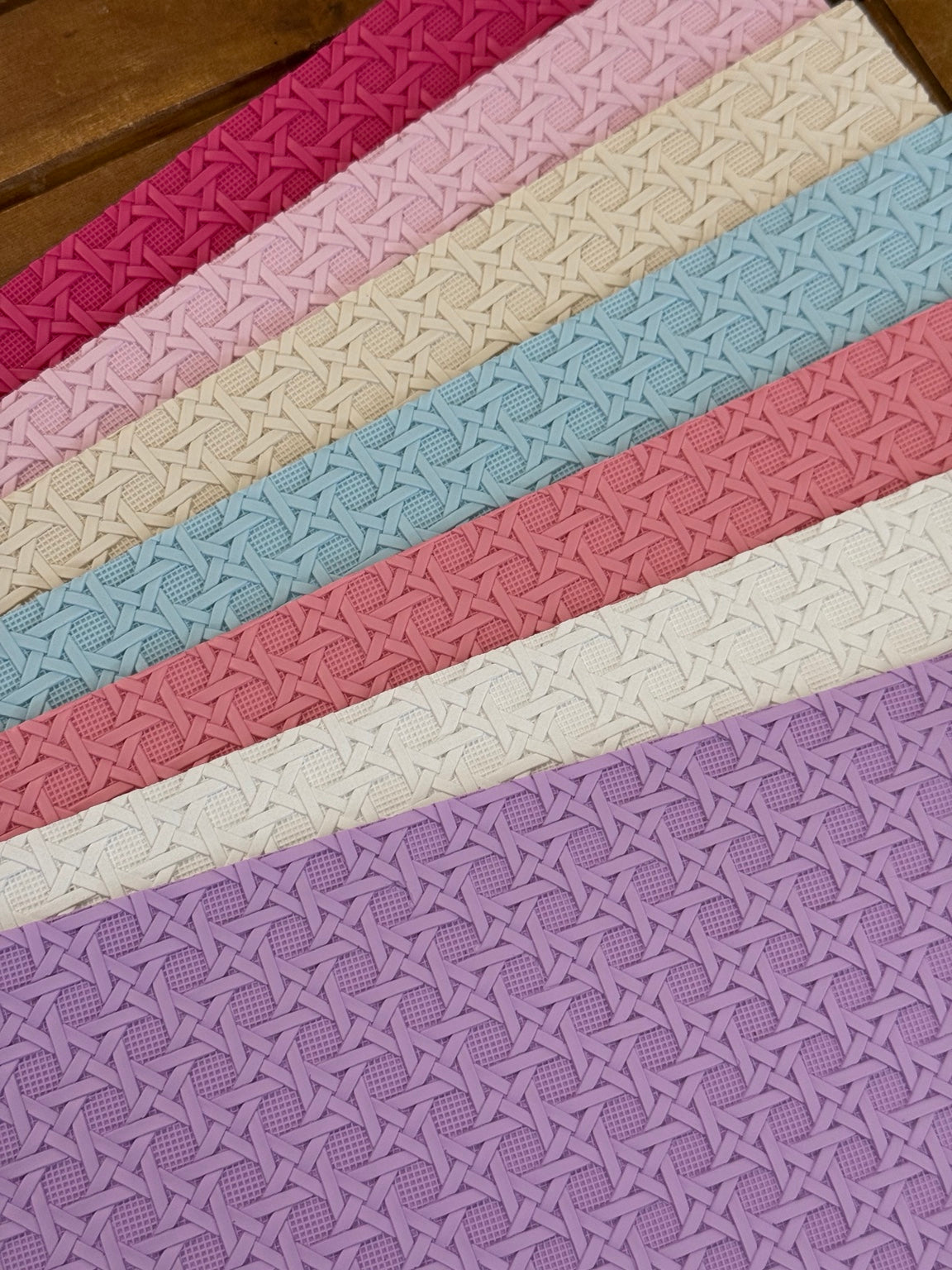 Cross hatch textured faux leather sheets in fuchsia, pale pink, cream, light blue, coral pink, white and lavender