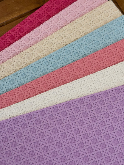 Cross hatch textured faux leather sheets in fuchsia, pale pink, cream, light blue, coral pink, white and lavender