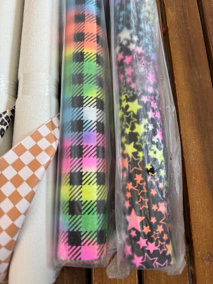 Faux leather print rolls with Christmas plaid, large and small leopard, chestnut checker, neon plaid and neon stars