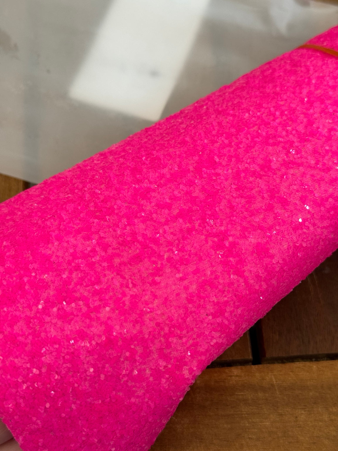 Close-up of neon pink semi chunky glitter faux leather texture
