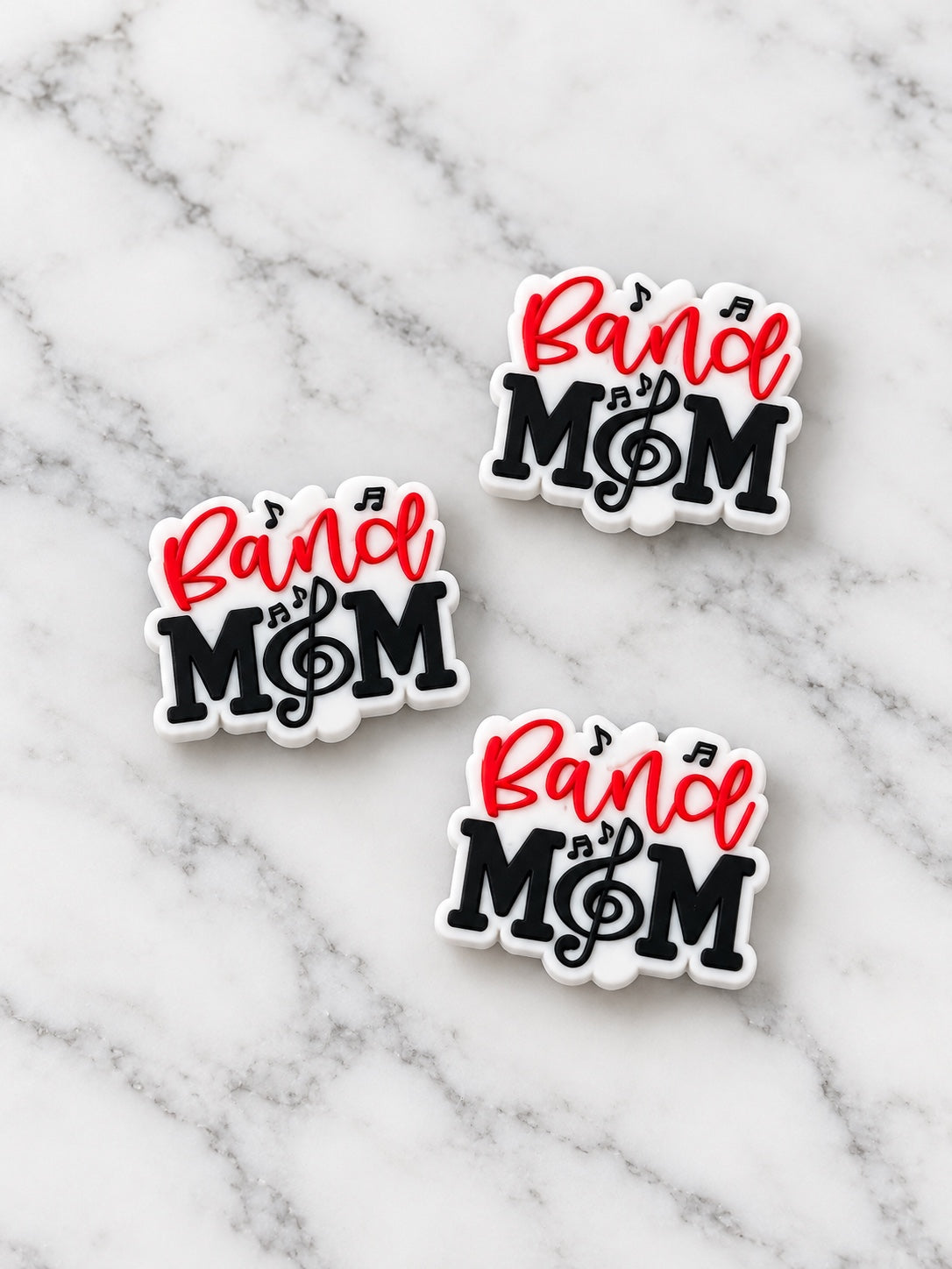 Red, black and white Band Mom silicone focals on white marble