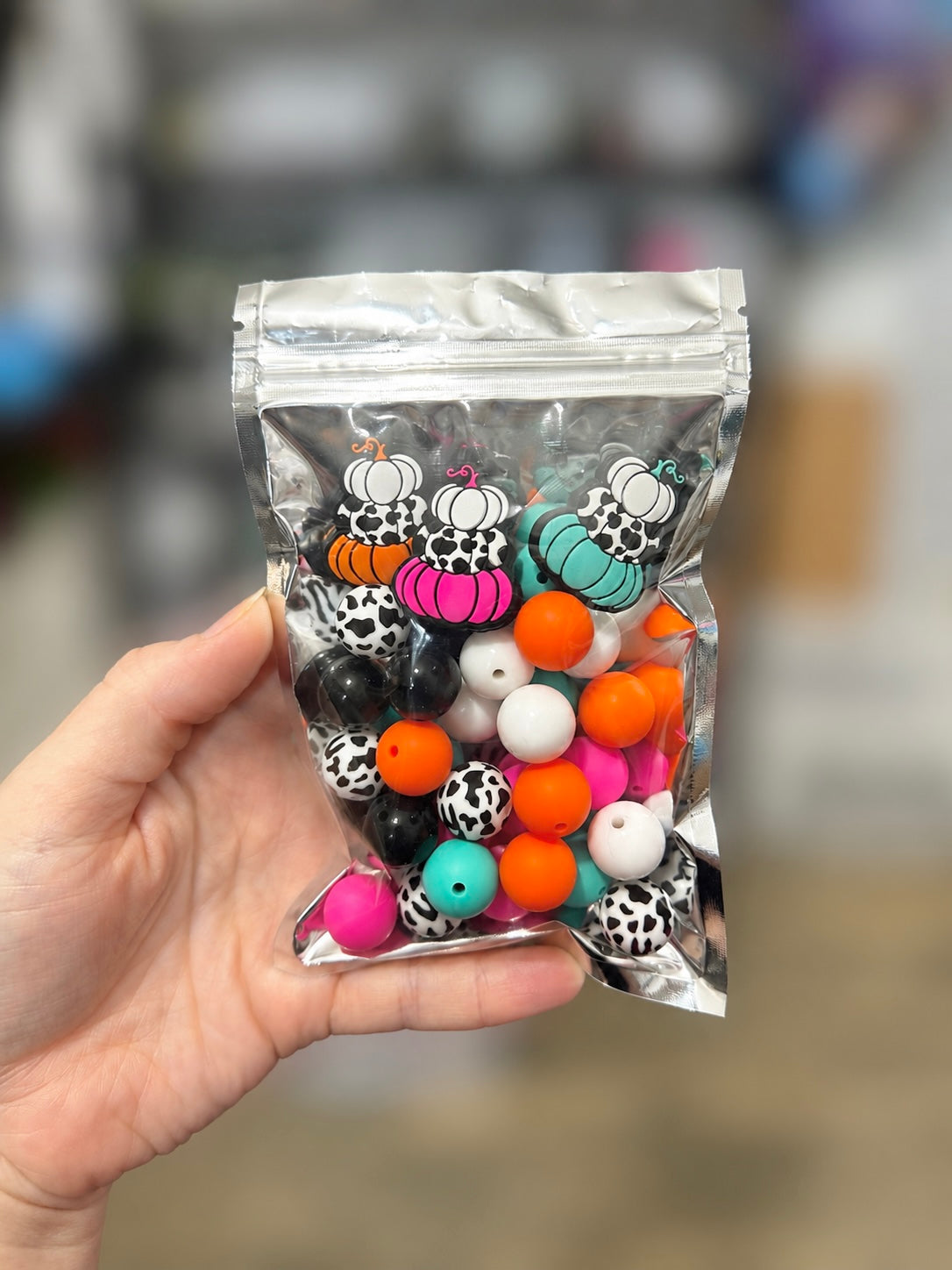 30+ piece neon cow print pumpkin curated silicone bead and focal mix in orange, pink, teal, black and white