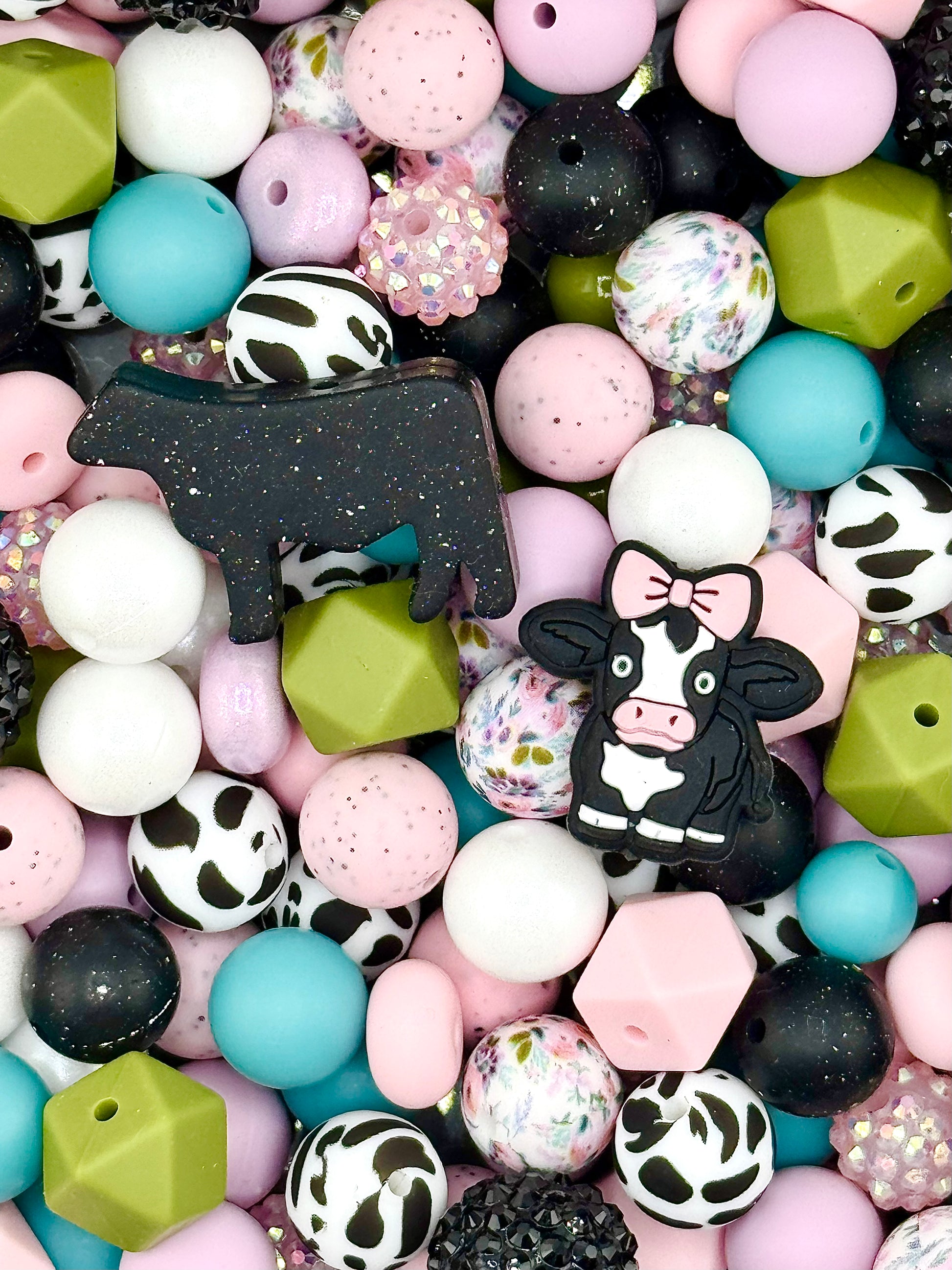 Pink cow themed silicone bead mix with floral prints, bow cow focal, black white cow beads, teal and olive accents for farmhouse and boutique accessories