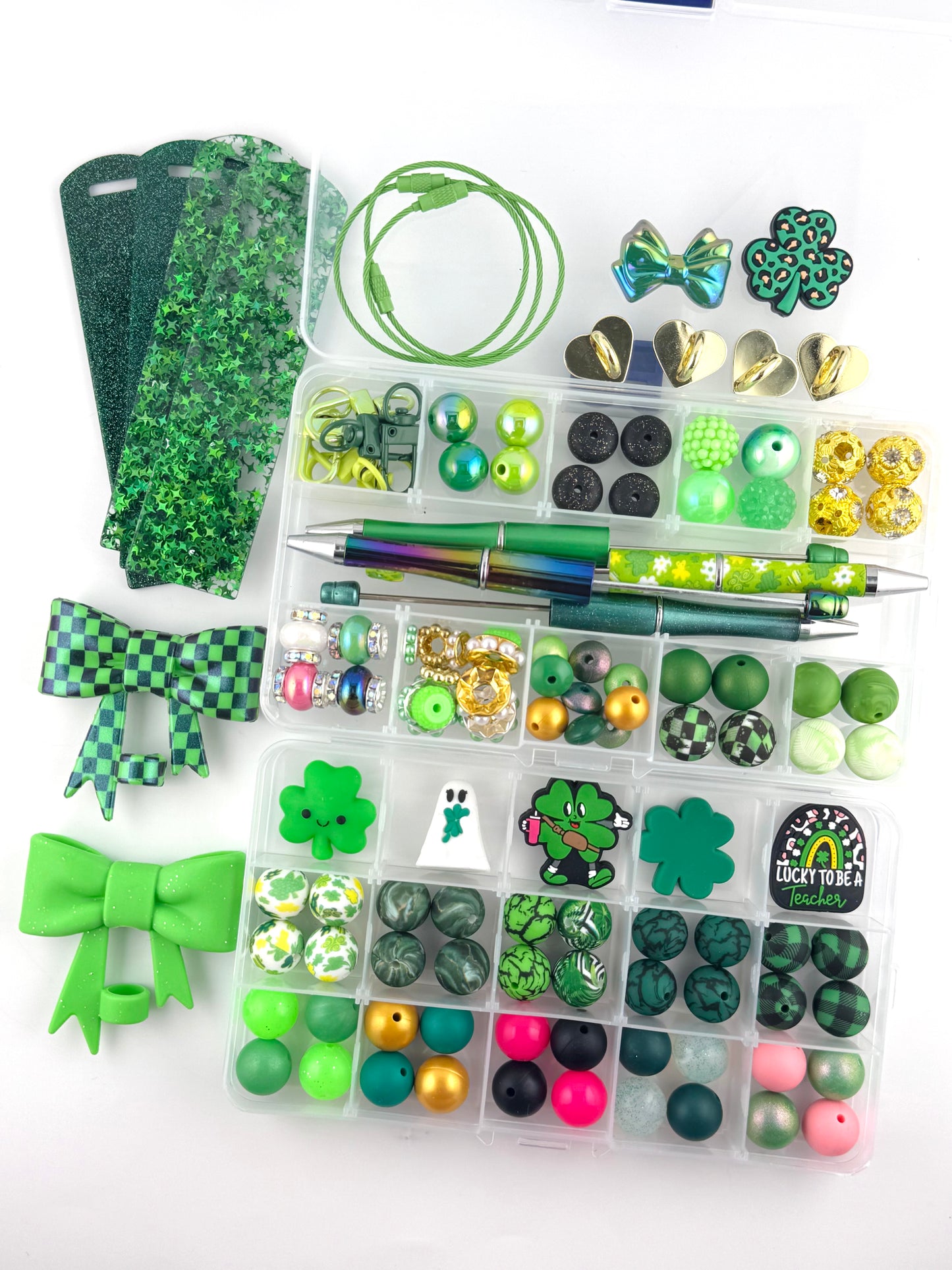122 piece St Patrick’s Day craft starter kit featuring green silicone beads, clover charms, bows, beadable pens, keychain hardware, glitter faux leather, and lucky themed accessories for DIY wristlets, pens, and keychains